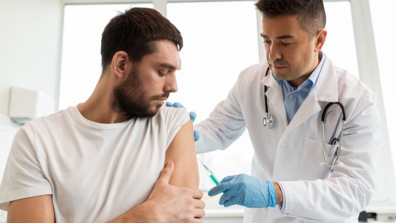 Doctor drawing blood from patient.